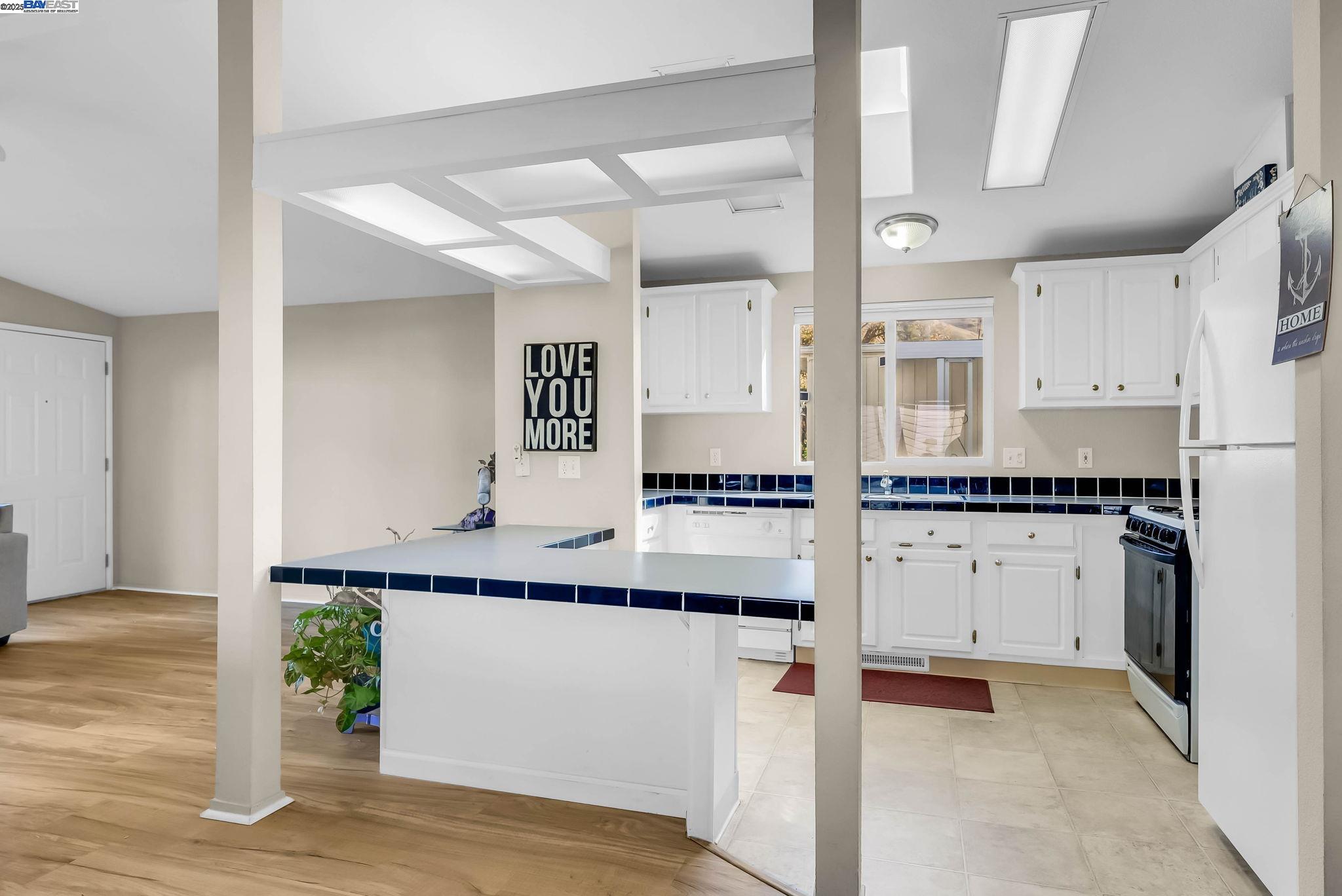 711 Old Canyon Road, Unit 176 Fremont, CA 94536 - Photo 13 of 41 a kitchen with granite countertop a sink and cabinets