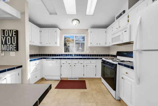 a white refrigerator freezer sitting inside of a kitchen