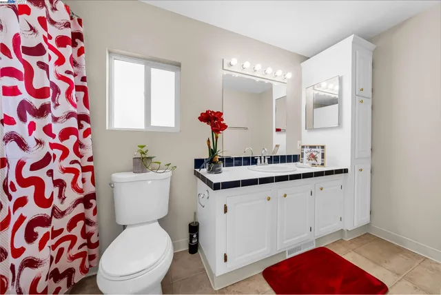 a bathroom with a sink vanity mirror and tub
