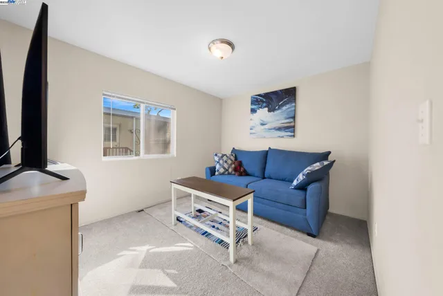 a living room with furniture and a walk in closet
