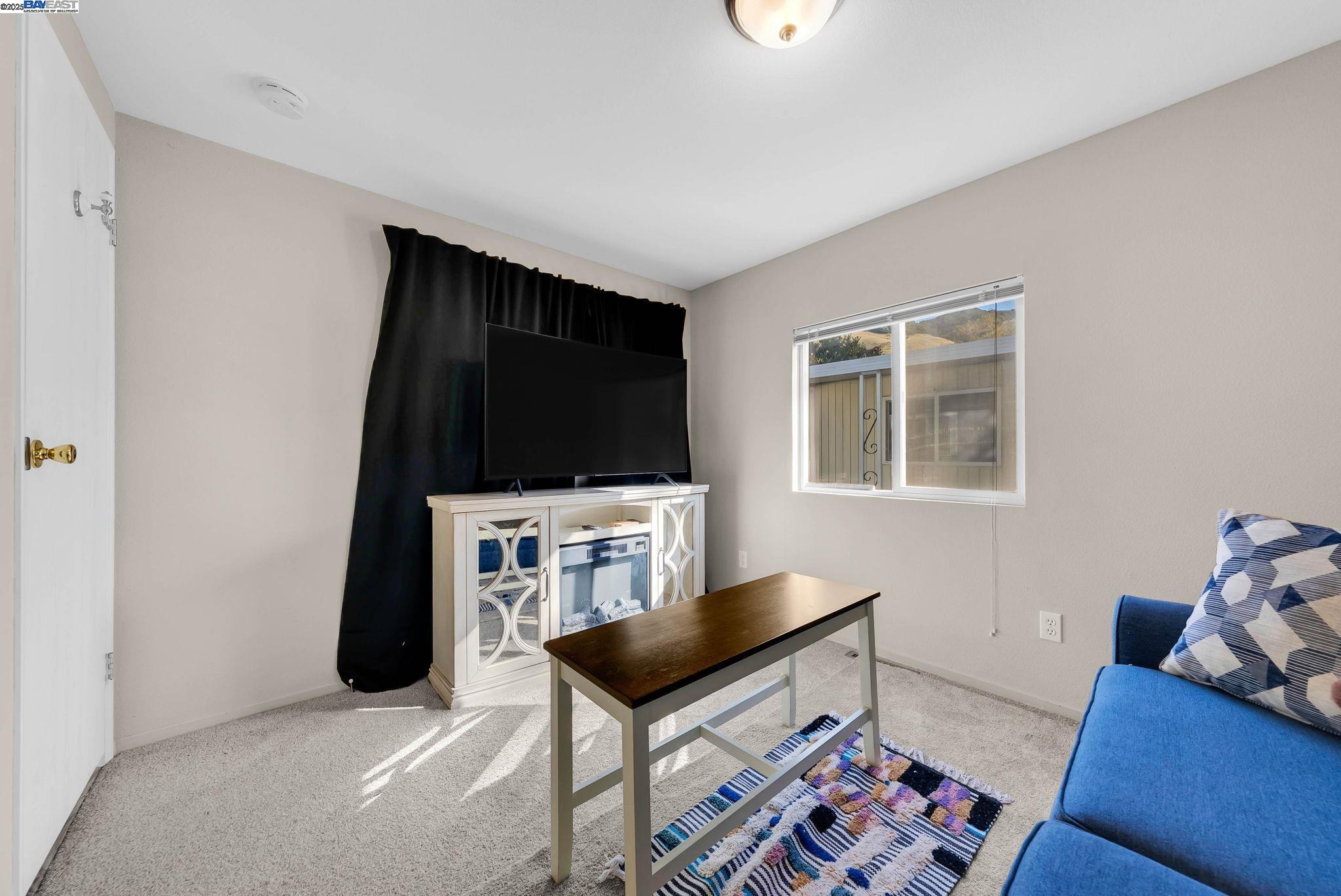 711 Old Canyon Road, Unit 176 Fremont, CA 94536 - Photo 26 of 41 a living room with furniture and a flat screen tv