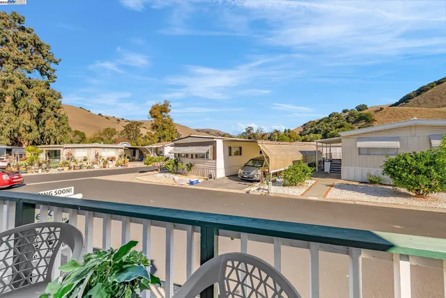 a city view from a balcony with chairs