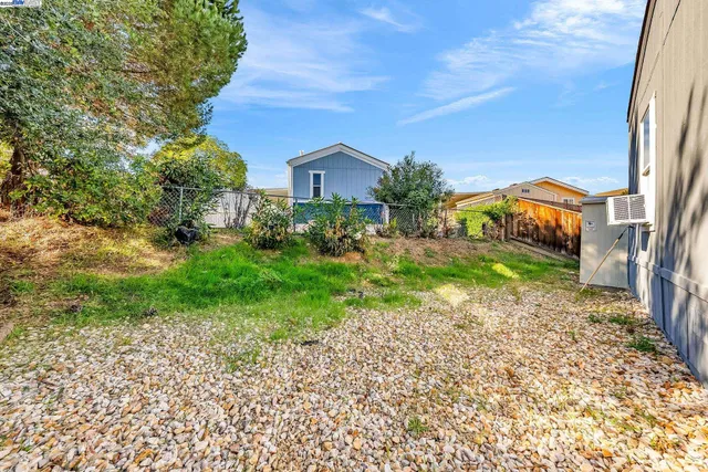 a view of a patio with chairs and tables on the patio