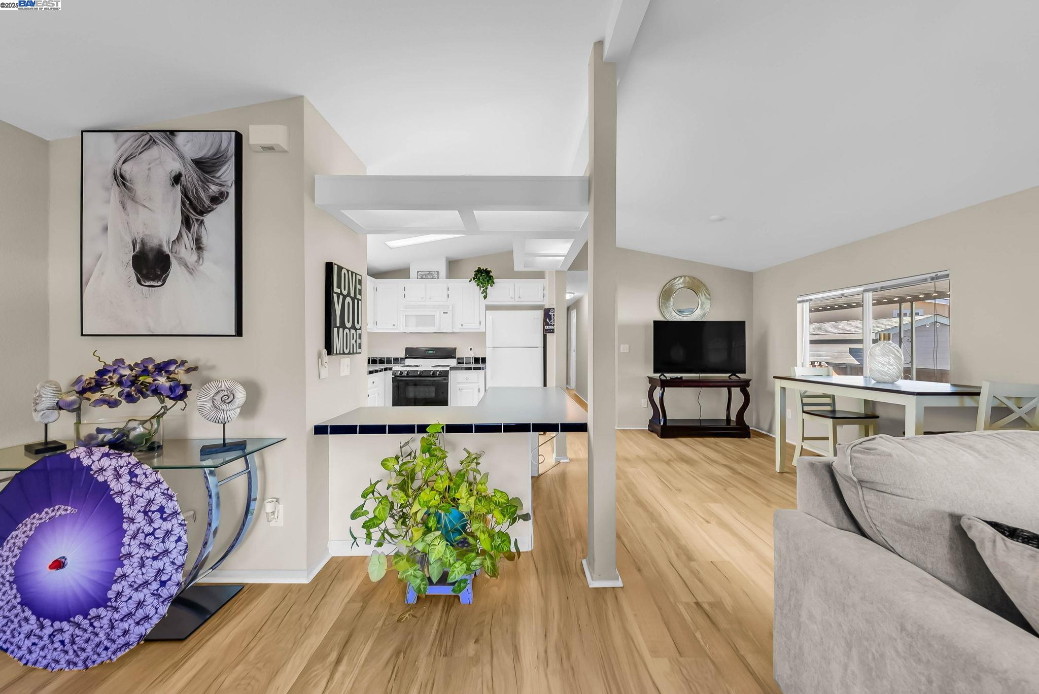 711 Old Canyon Road, Unit 176 Fremont, CA 94536 - Photo 8 of 41 a living room with furniture and wooden floor