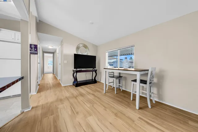 a view of a kitchen with kitchen island and stainless steel appliances
