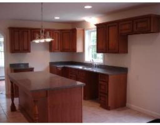 128 Dunham Road Warren, MA 01083 - Photo 5 of 5 a kitchen with stainless steel appliances granite countertop a sink a stove and a refrigerator