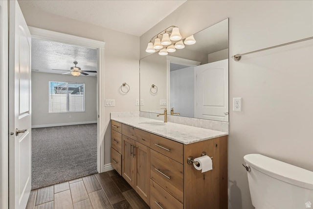 2028 West Grace Way Layton, UT 84041 - Photo 16 of 36 Bathroom featuring vanity, wood tiled floors, and a ceiling fan