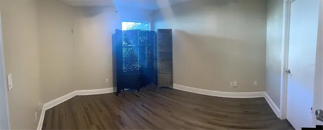 an empty room with closet and wooden floor