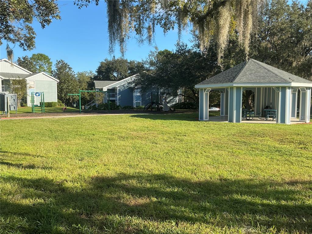715 Sugar Bay Way, Unit 107 Lake Mary, FL 32746 - Photo 36 of 48 a front view of a house with a garden