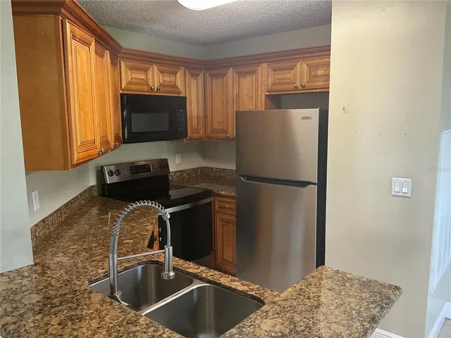 a kitchen with a refrigerator and a sink