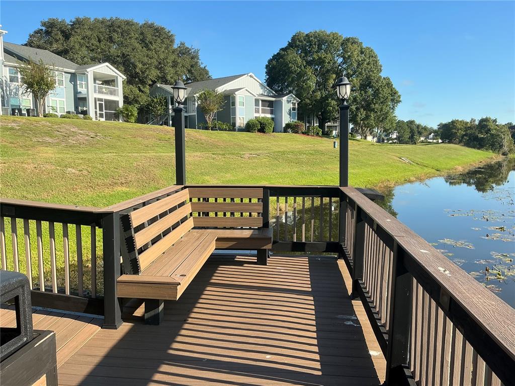 715 Sugar Bay Way, Unit 107 Lake Mary, FL 32746 - Photo 42 of 48 a view of a balcony with wooden floor and iron stairs