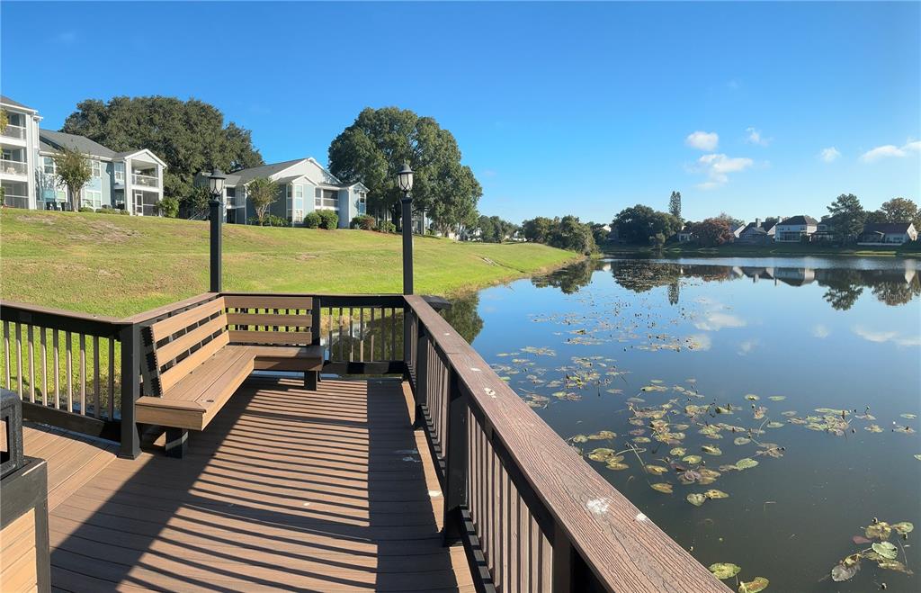 715 Sugar Bay Way, Unit 107 Lake Mary, FL 32746 - Photo 43 of 48 a view of a lake with couches and wooden floor