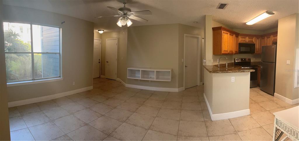 715 Sugar Bay Way, Unit 107 Lake Mary, FL 32746 - Photo 7 of 48 a view of a kitchen with furniture and stainless steel appliances