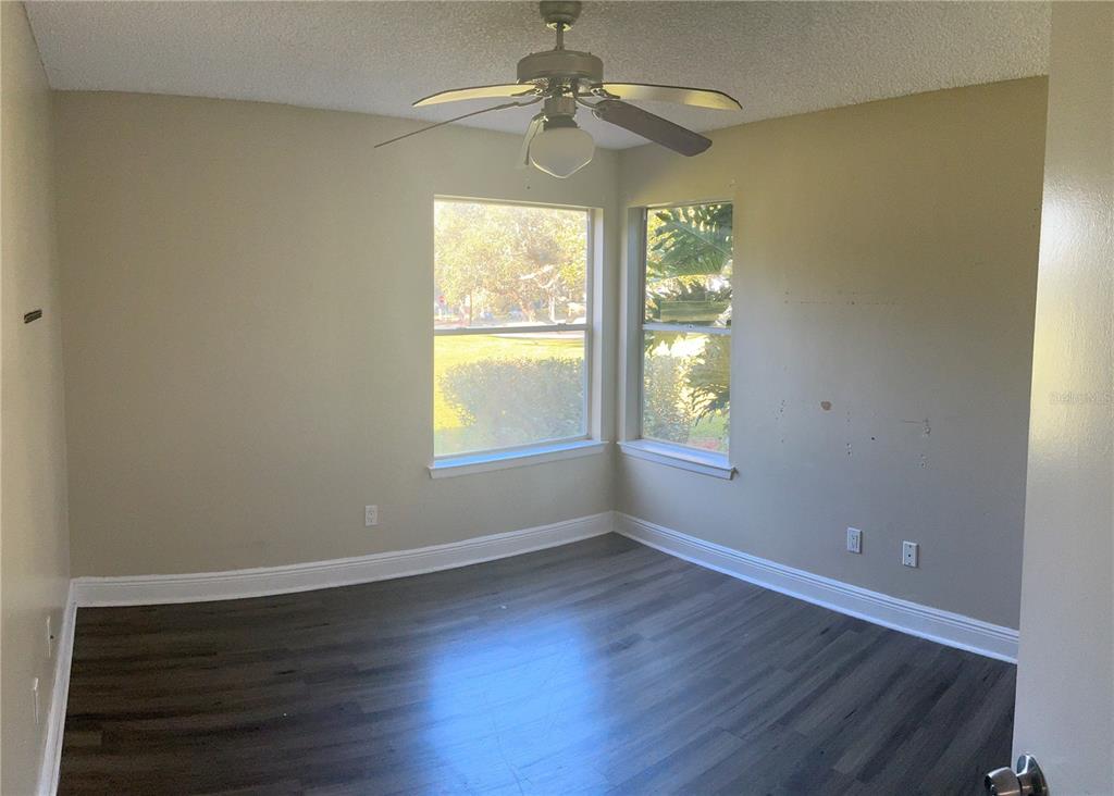 715 Sugar Bay Way, Unit 107 Lake Mary, FL 32746 - Photo 9 of 48 a view of an empty room with window and wooden floor