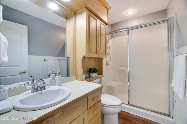 a bathroom with a granite countertop sink toilet and shower