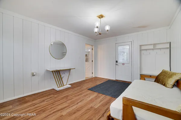 a bedroom with a bed and a chandelier