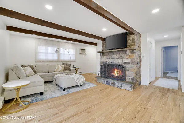 a living room with furniture and a fireplace