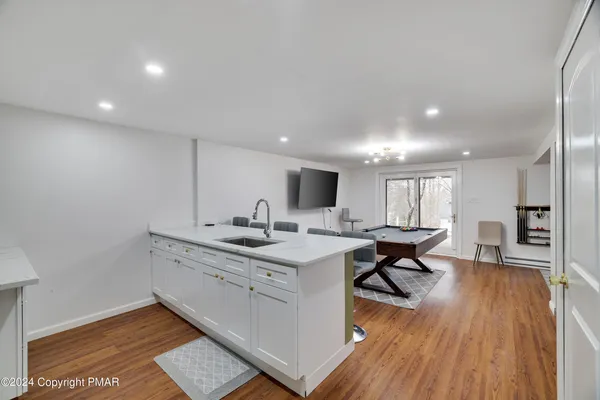 a view of kitchen and sink with wooden floor