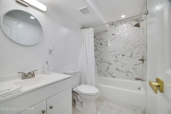 a bathroom with a sink toilet and shower