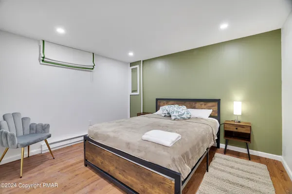a bedroom with a bed and a chair