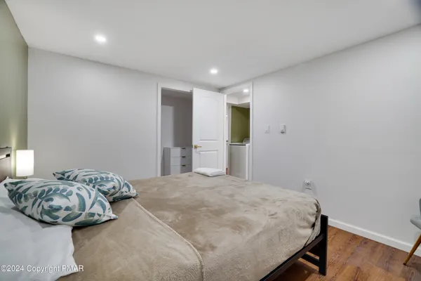 a spacious bedroom with a bed and a window