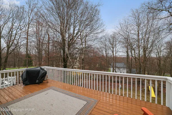 a view of a patio with wooden floor and fence