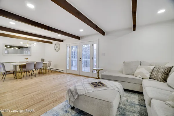 a living room with furniture and large window
