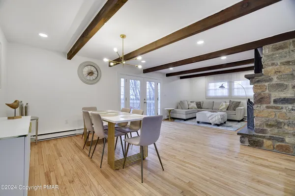 a view of a dining room with furniture window and wooden floor