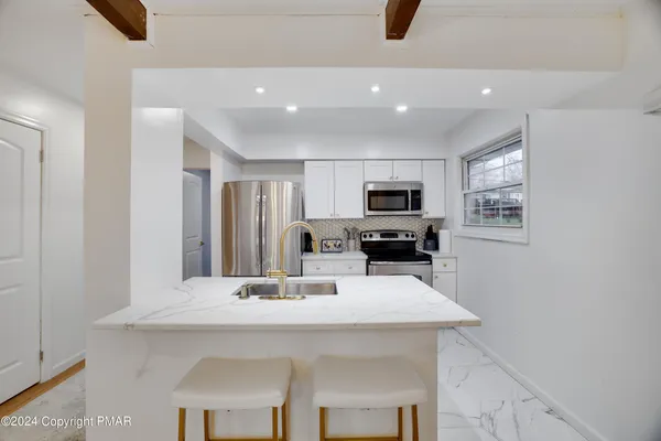 a kitchen with refrigerator and microwave