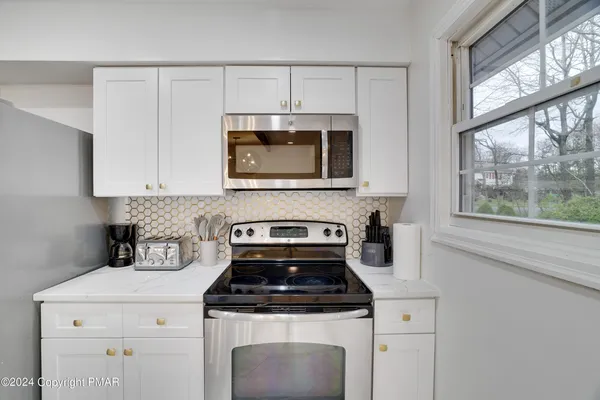 a stove top oven sitting inside of a kitchen
