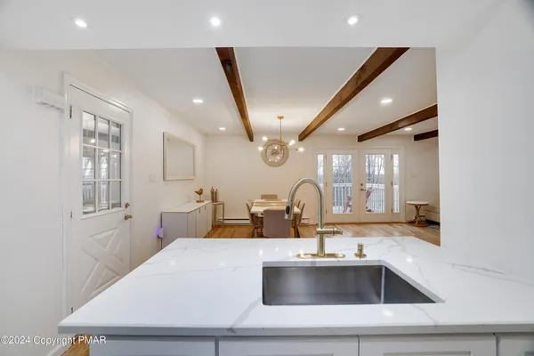 a kitchen with a sink and a refrigerator with a sink