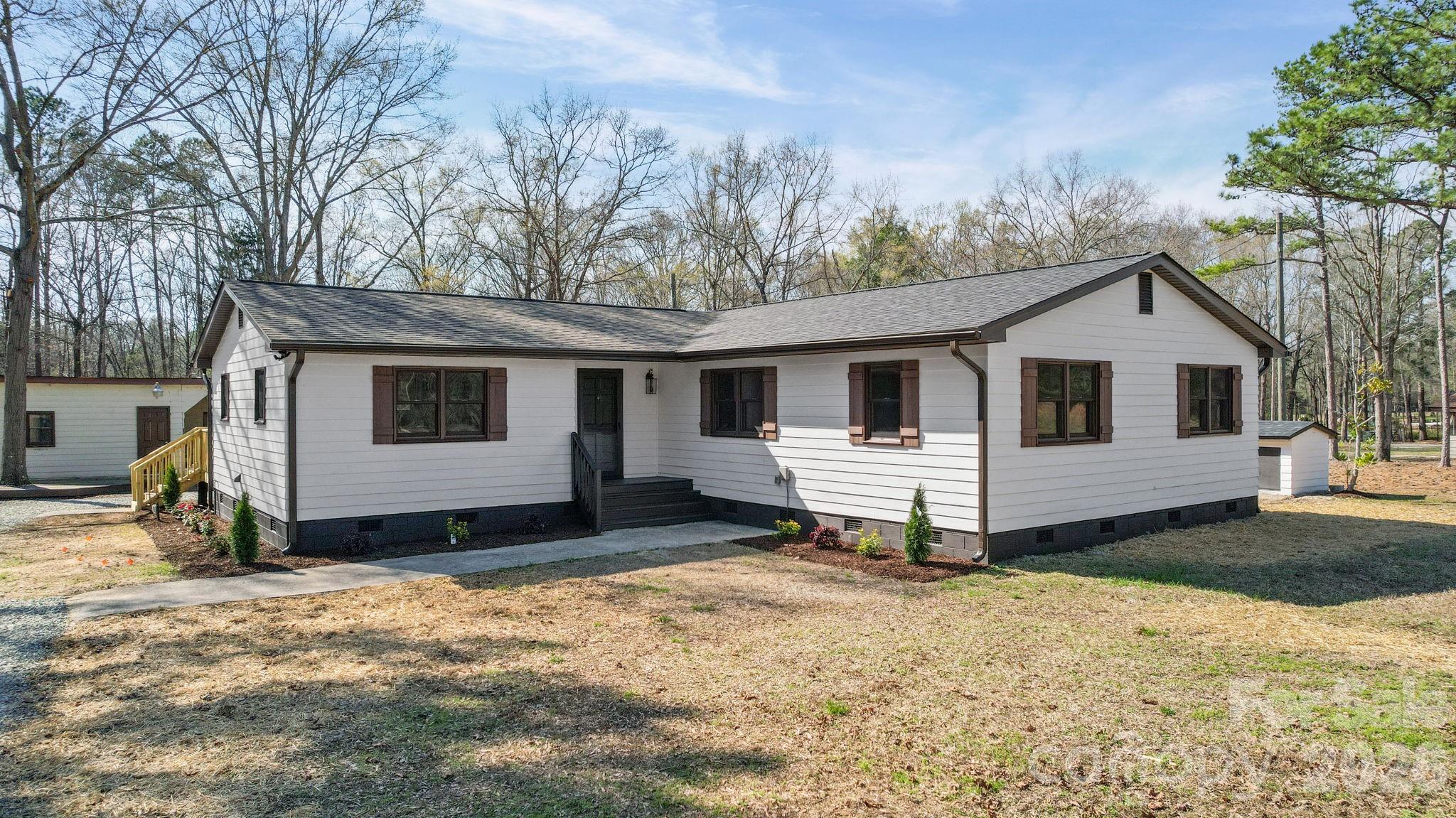 a view of a house with yard covered in snow