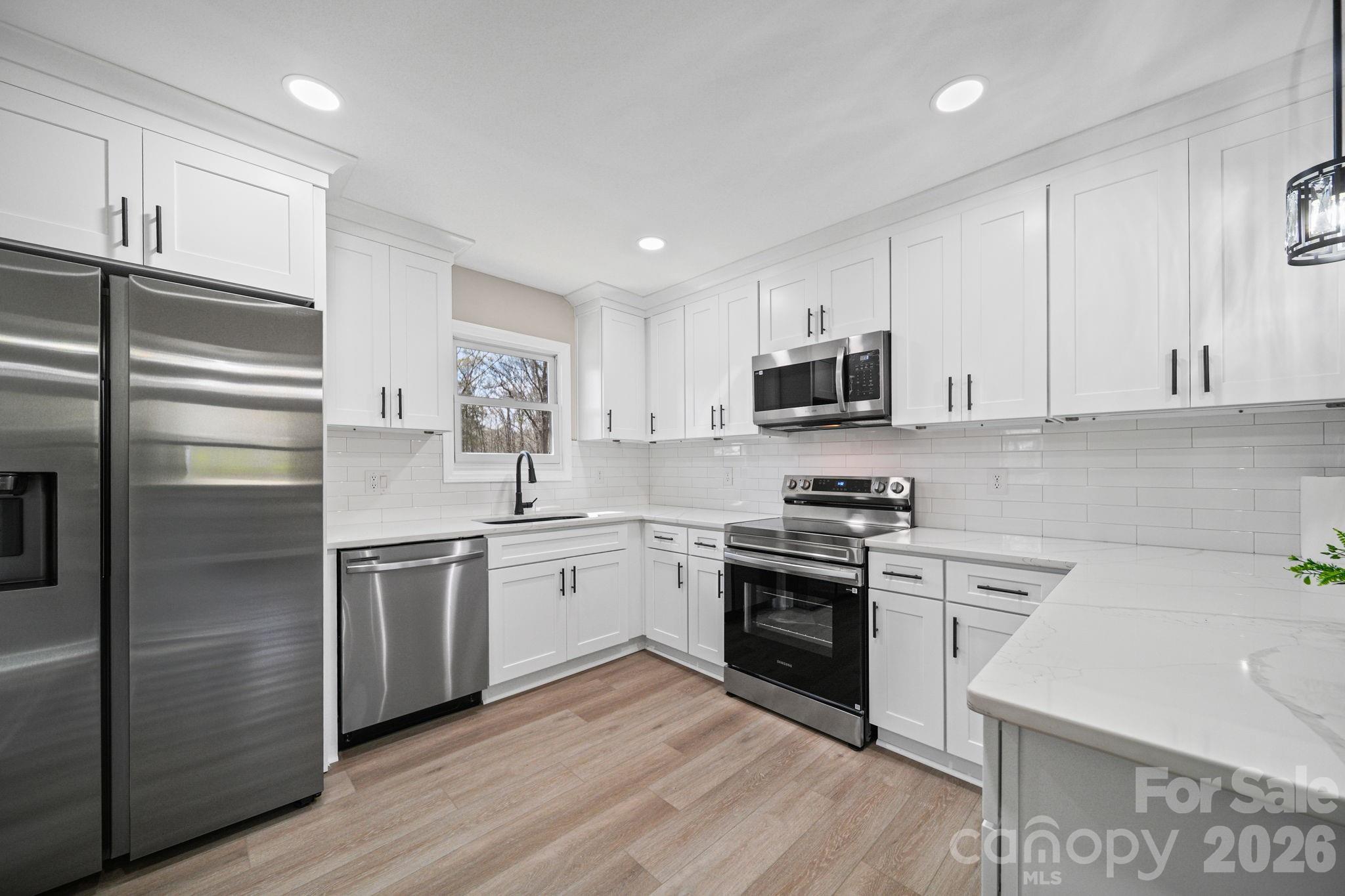 5808 Flint Ridge Marshville, NC 28103 - Photo 14 of 38 a kitchen with granite countertop stainless steel appliances and wooden cabinets
