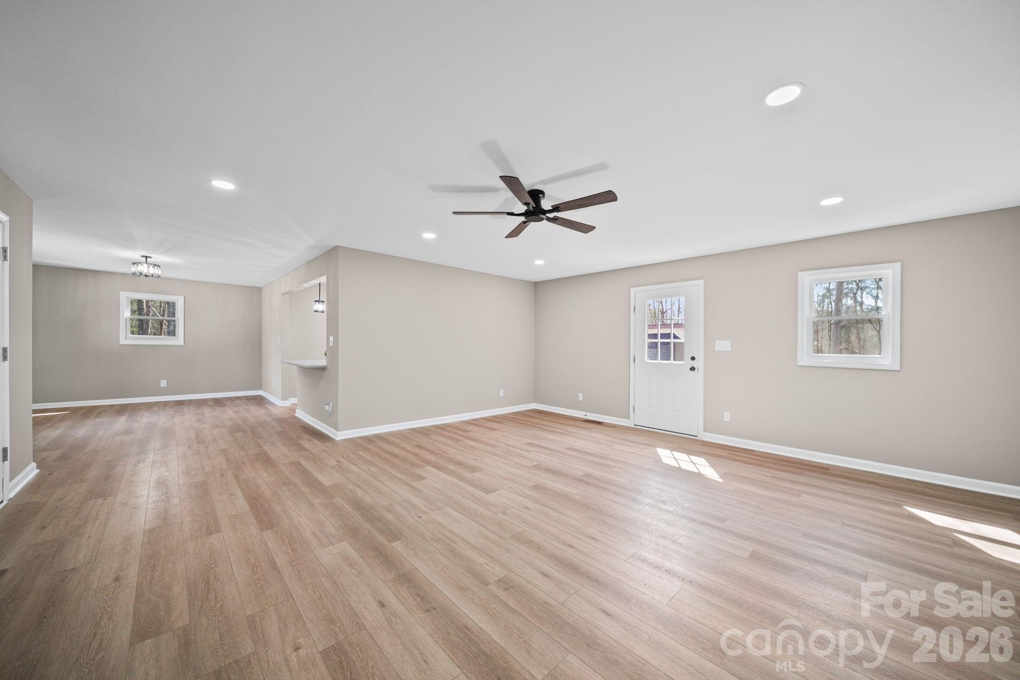 5808 Flint Ridge Marshville, NC 28103 - Photo 16 of 38 a view of a livingroom with a ceiling fan and wooden floor