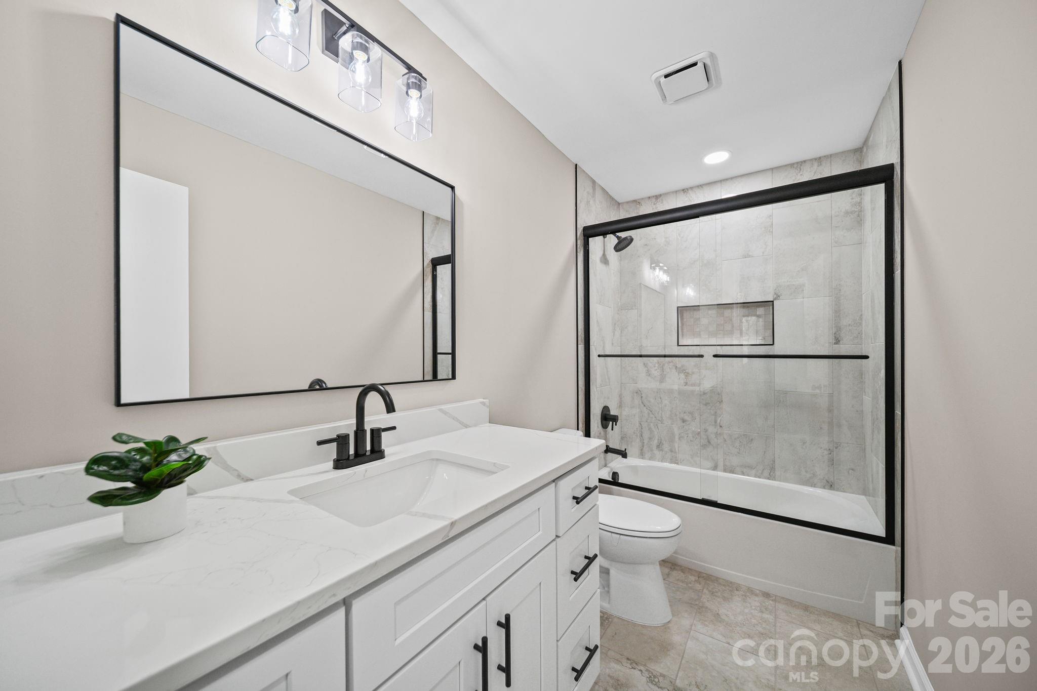 5808 Flint Ridge Marshville, NC 28103 - Photo 18 of 38 a bathroom with a sink a toilet and shower