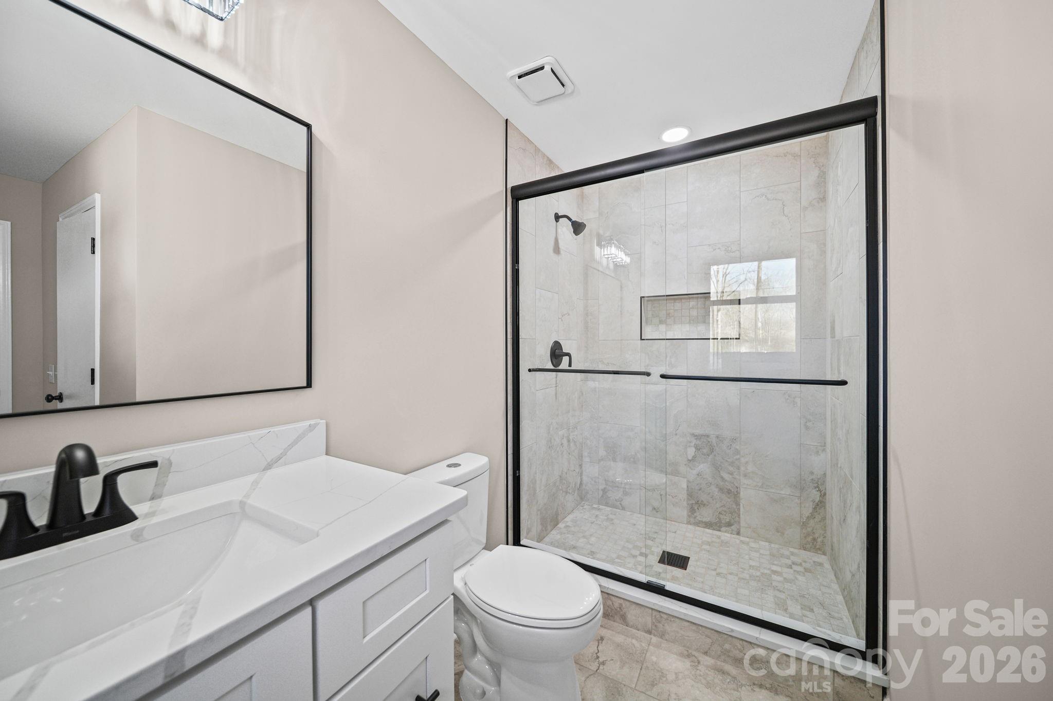 5808 Flint Ridge Marshville, NC 28103 - Photo 19 of 38 a bathroom with a granite countertop sink toilet and shower