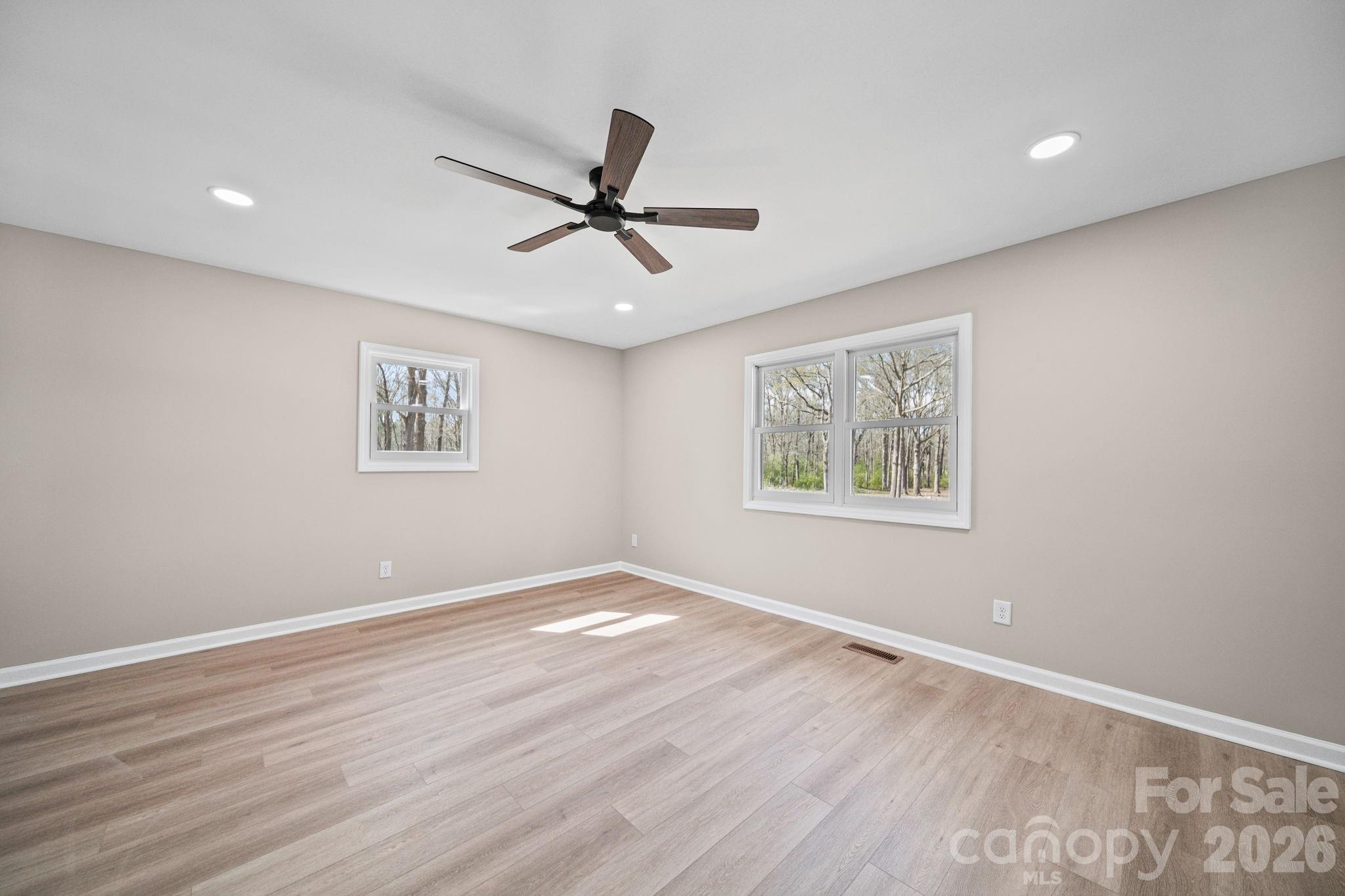 5808 Flint Ridge Marshville, NC 28103 - Photo 20 of 38 a view of empty room with wooden floor and fan