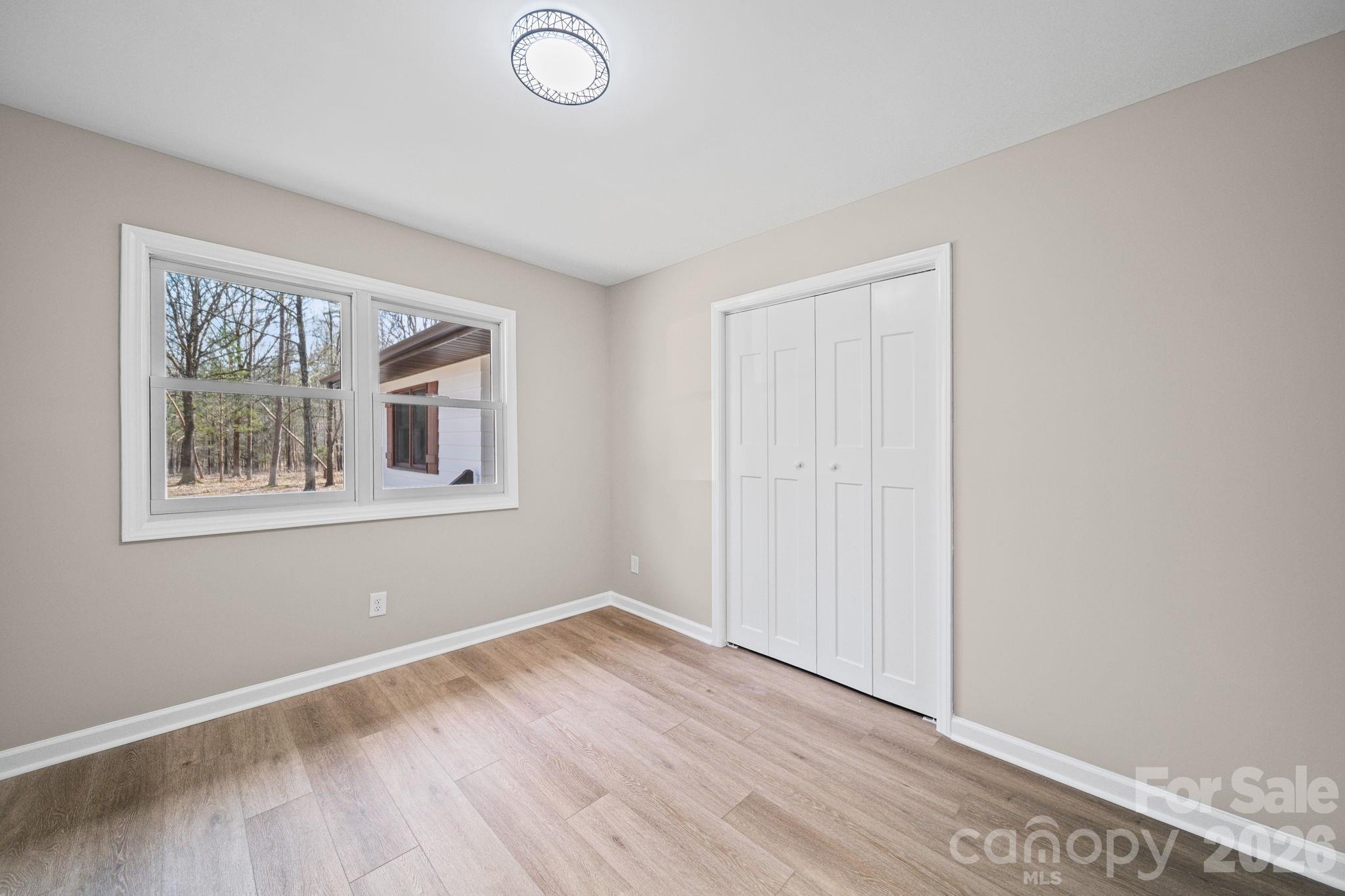 5808 Flint Ridge Marshville, NC 28103 - Photo 23 of 38 a view of empty room with wooden floor