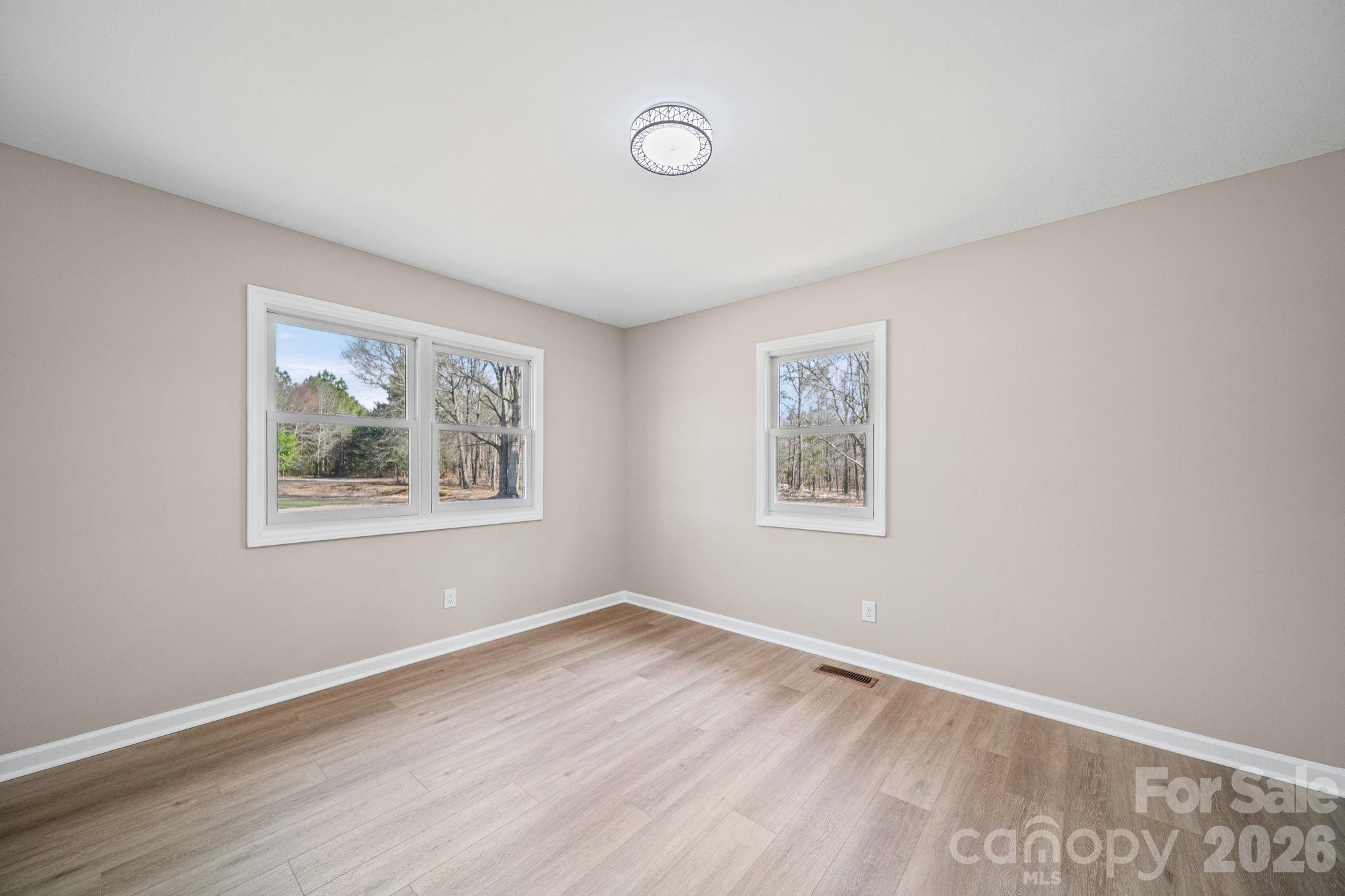 5808 Flint Ridge Marshville, NC 28103 - Photo 25 of 38 a view of an empty room with window and wooden floor