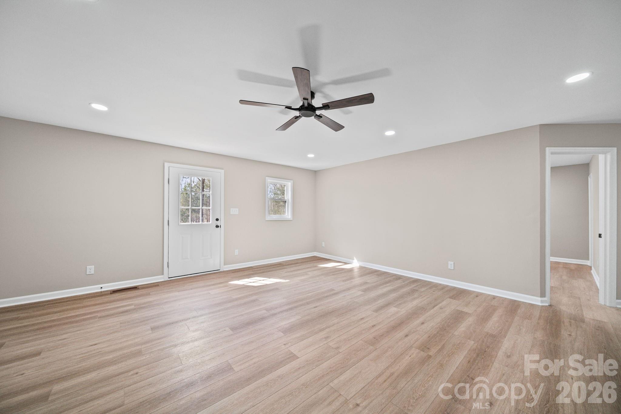 5808 Flint Ridge Marshville, NC 28103 - Photo 26 of 38 wooden floor in an empty room with a window