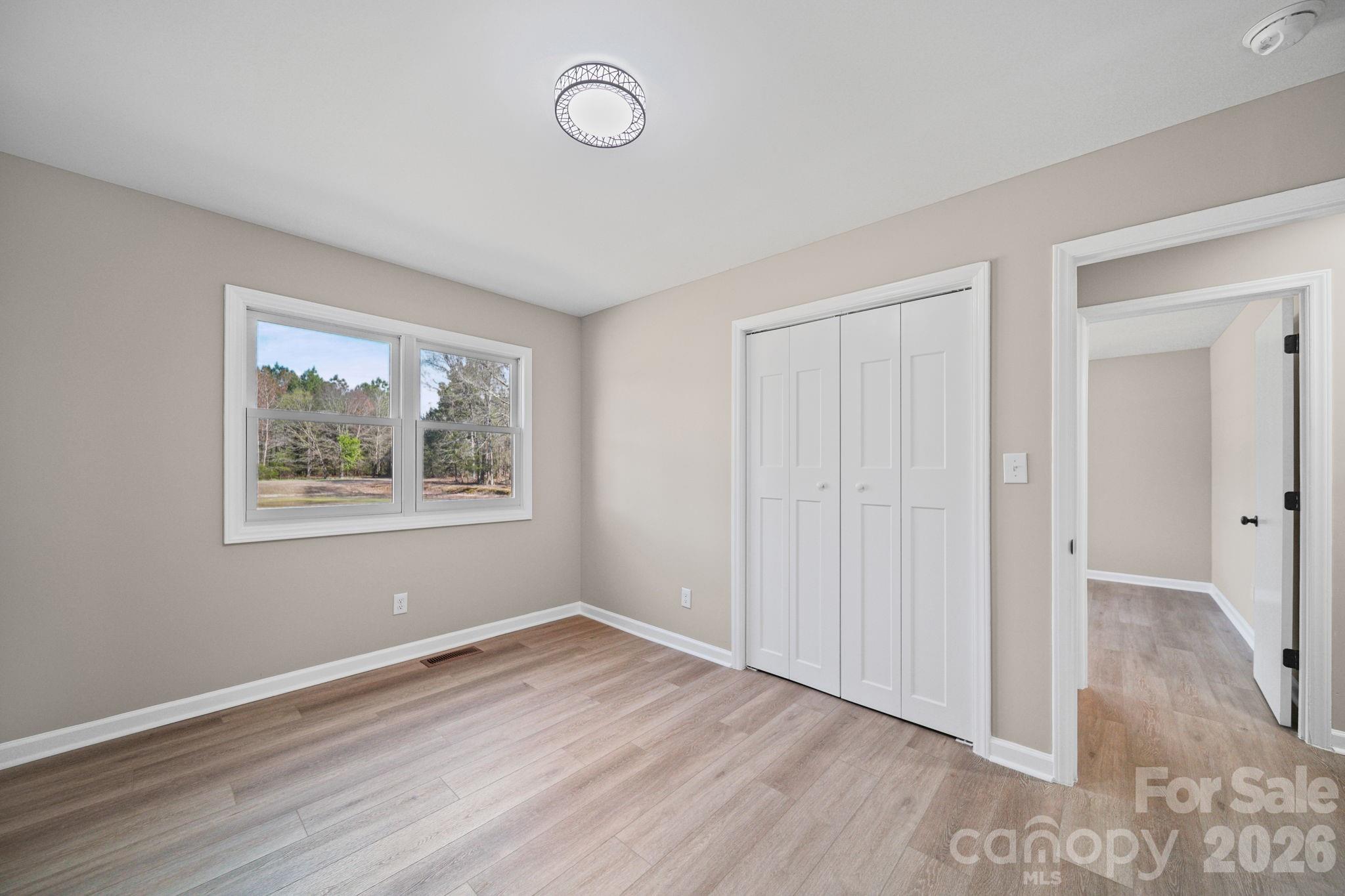 5808 Flint Ridge Marshville, NC 28103 - Photo 27 of 38 an empty room with wooden floor and window