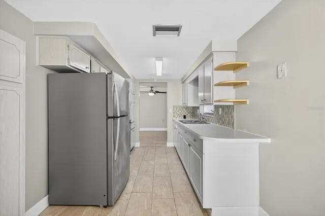 a view of an empty room with a ceiling fan