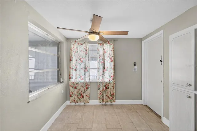 a view of a livingroom with a ceiling fan and window
