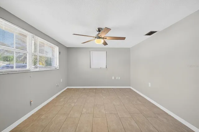 a front view of a house with a garden and yard