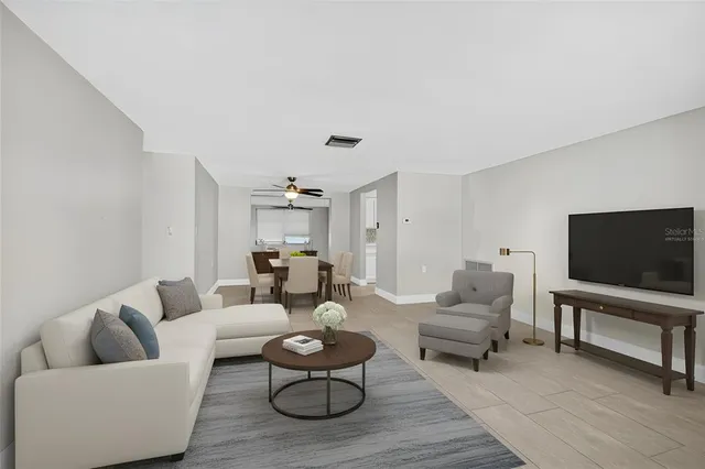 an empty room with painting on the wall and a window