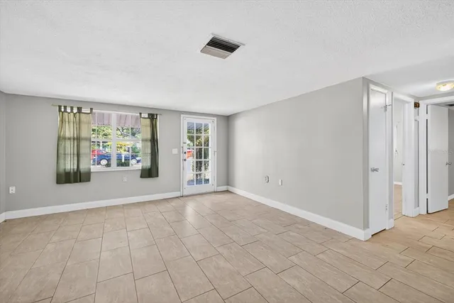 a bathroom with a granite countertop sink a toilet a mirror and shower