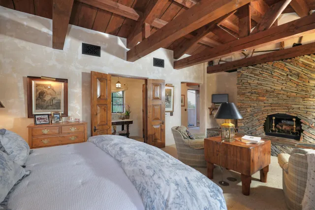 a bedroom with furniture and a fireplace