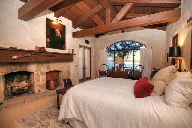 a bedroom with a bed and a fireplace