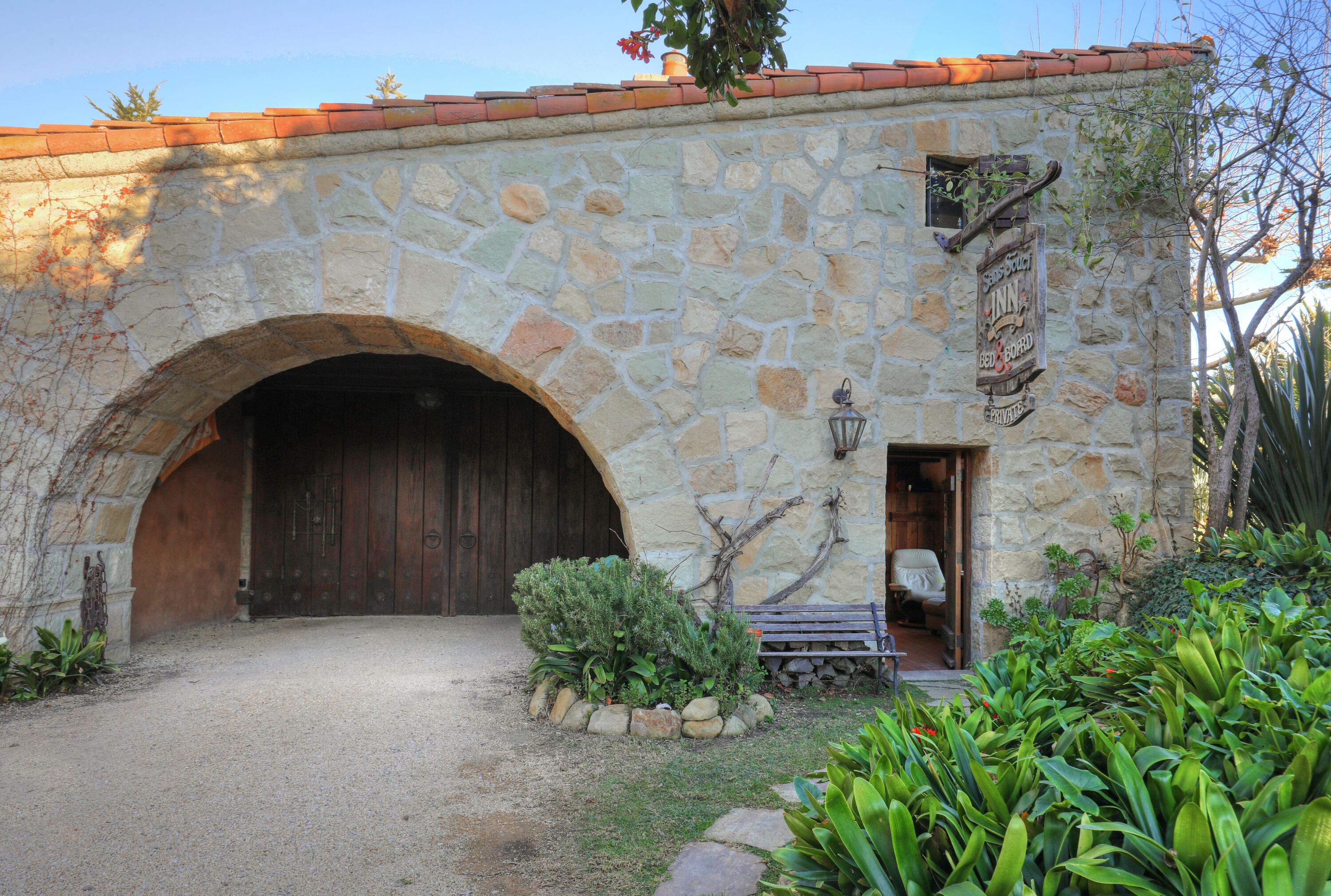 7 Creciente Drive Santa Barbara, CA 93110 - Photo 2 of 16 a front view of a stone house with a yard