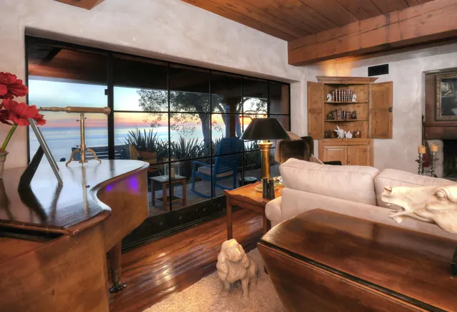 a living room with furniture and a floor to ceiling window